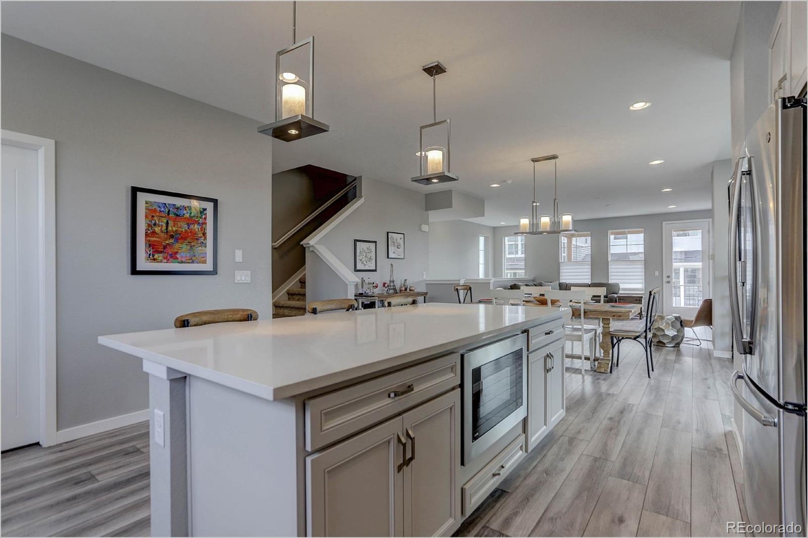 8928 Delacorte Street Highlands Ranch, CO 80129 - Photo 8 of 26 a kitchen with a sink appliances and wooden floor