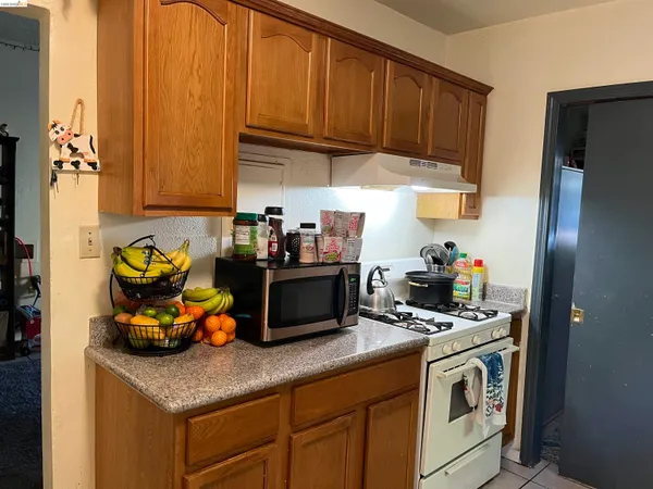 a kitchen with stainless steel appliances granite countertop a sink a refrigerator and a stove