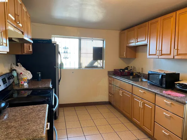 a kitchen with granite countertop cabinets and steel appliances