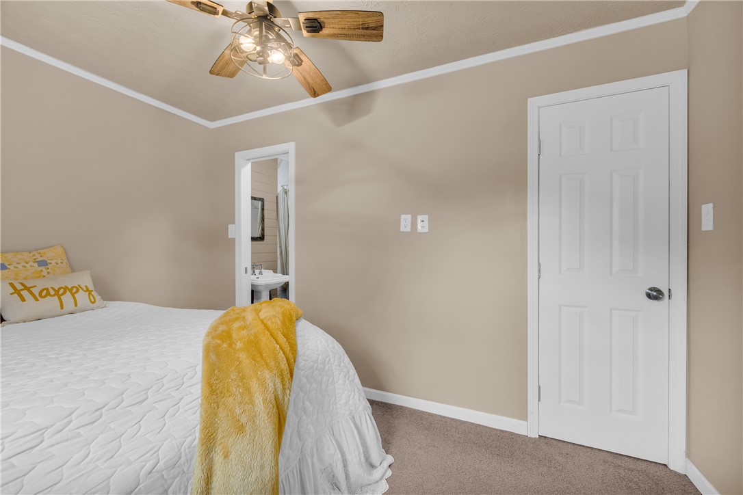 3030 Smith McGee Road Iva, SC 29655 - Photo 40 of 46 Comfortable bedroom featuring a ceiling fan and plush carpet flooring.