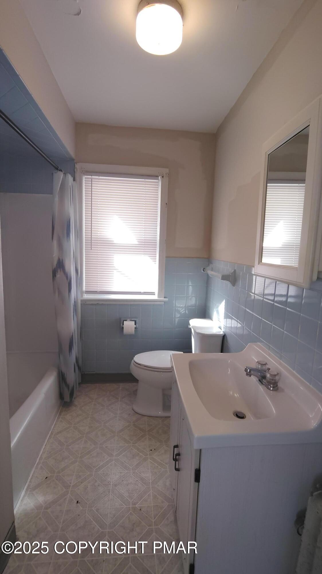 258 Factory Street Luzerne, PA 18709 - Photo 8 of 22 a bathroom with a sink a toilet and mirror