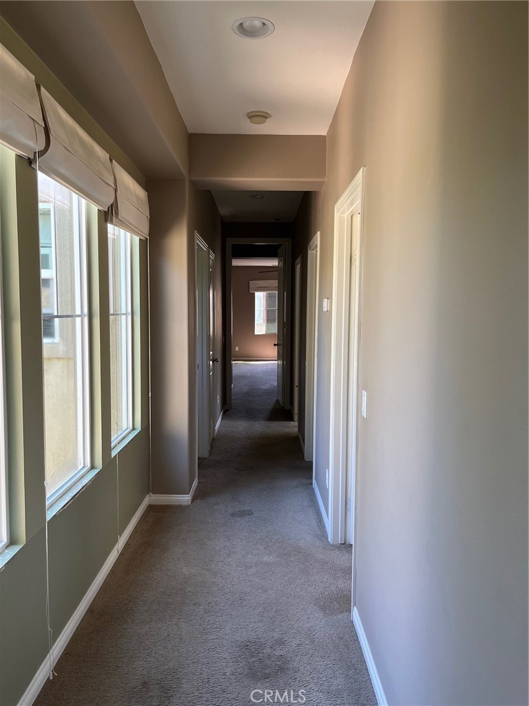 31885 Jaybee Lane Temecula, CA 92592 - Photo 15 of 35 a view of a hallway with wooden shelves and windows
