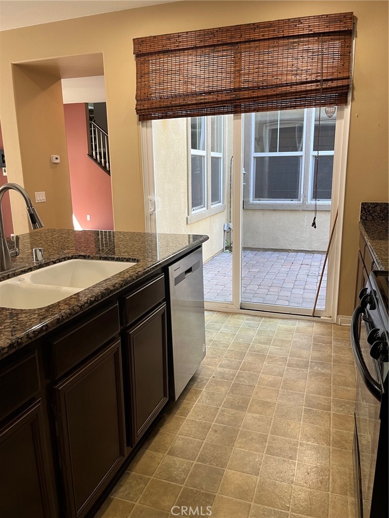 31885 Jaybee Lane Temecula, CA 92592 - Photo 4 of 35 a bathroom with a granite countertop sink and a mirror