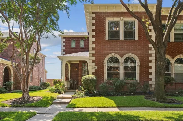 a front view of a house with yard and green space