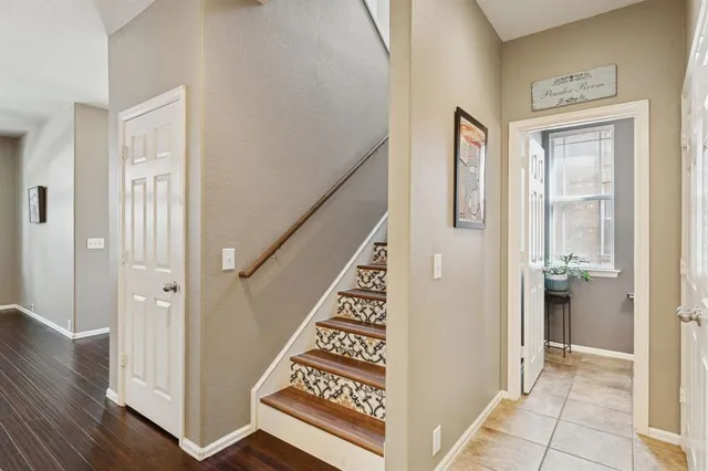 a view of a hallway with wooden floor and entryway