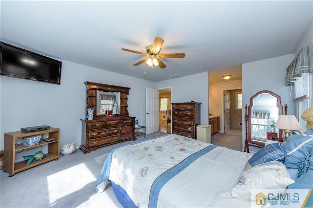 12 Thompson Bridge Road Jackson, NJ 08527 - Photo 12 of 25 a bedroom with furniture and a flat screen tv