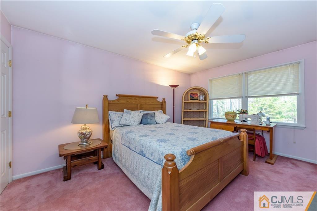 12 Thompson Bridge Road Jackson, NJ 08527 - Photo 15 of 25 a bedroom with a bed and a table in it