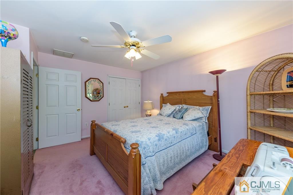 12 Thompson Bridge Road Jackson, NJ 08527 - Photo 16 of 25 a bedroom with a bed and a chandelier