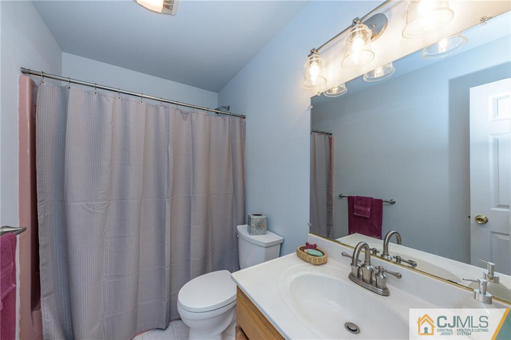 12 Thompson Bridge Road Jackson, NJ 08527 - Photo 19 of 25 a bathroom with a sink a toilet and shower curtain