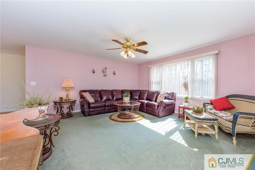 12 Thompson Bridge Road Jackson, NJ 08527 - Photo 4 of 25 a living room with furniture ceiling fan and a window