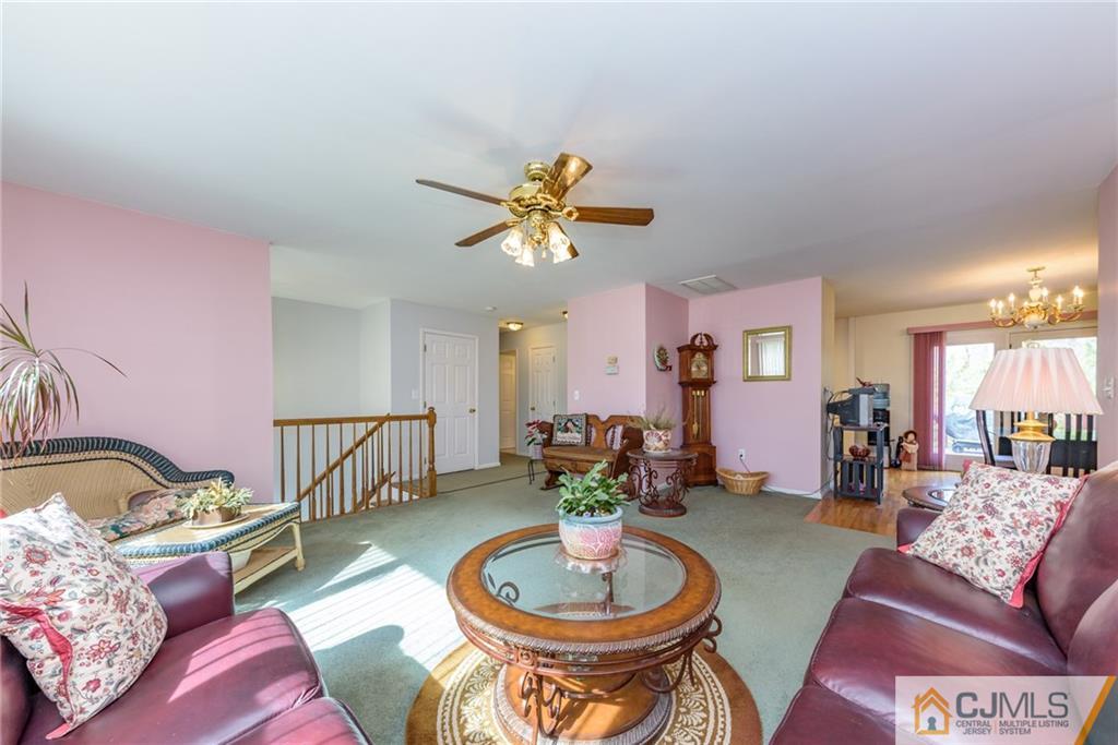 12 Thompson Bridge Road Jackson, NJ 08527 - Photo 5 of 25 a living room with furniture and a chandelier