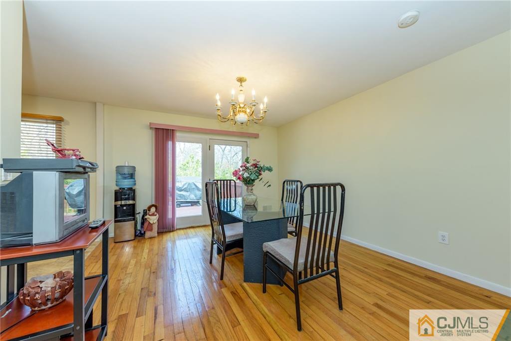 12 Thompson Bridge Road Jackson, NJ 08527 - Photo 6 of 25 a view of a dining room with furniture a chandelier and wooden floor