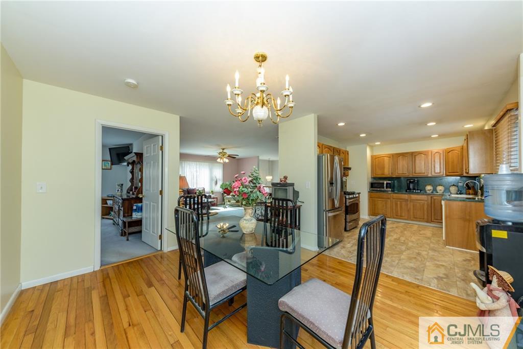 12 Thompson Bridge Road Jackson, NJ 08527 - Photo 7 of 25 a view of a dining room with furniture and a chandelier