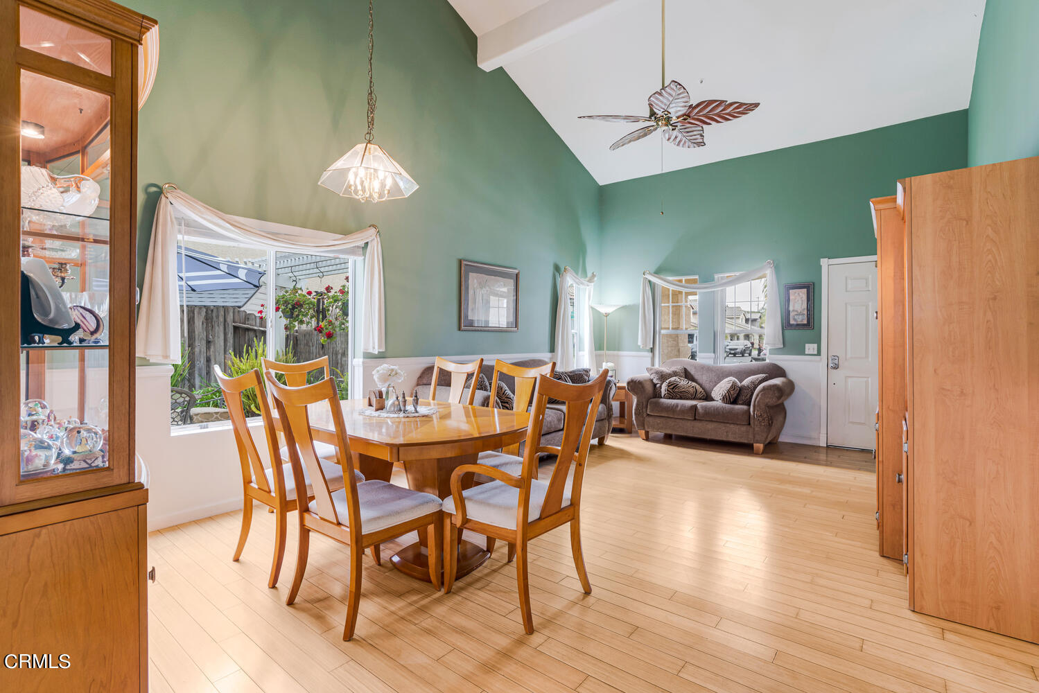 2911 Pico Place Oxnard, CA 93033 - Photo 4 of 25 a dining room with furniture a kitchen wooden floor and a chandelier