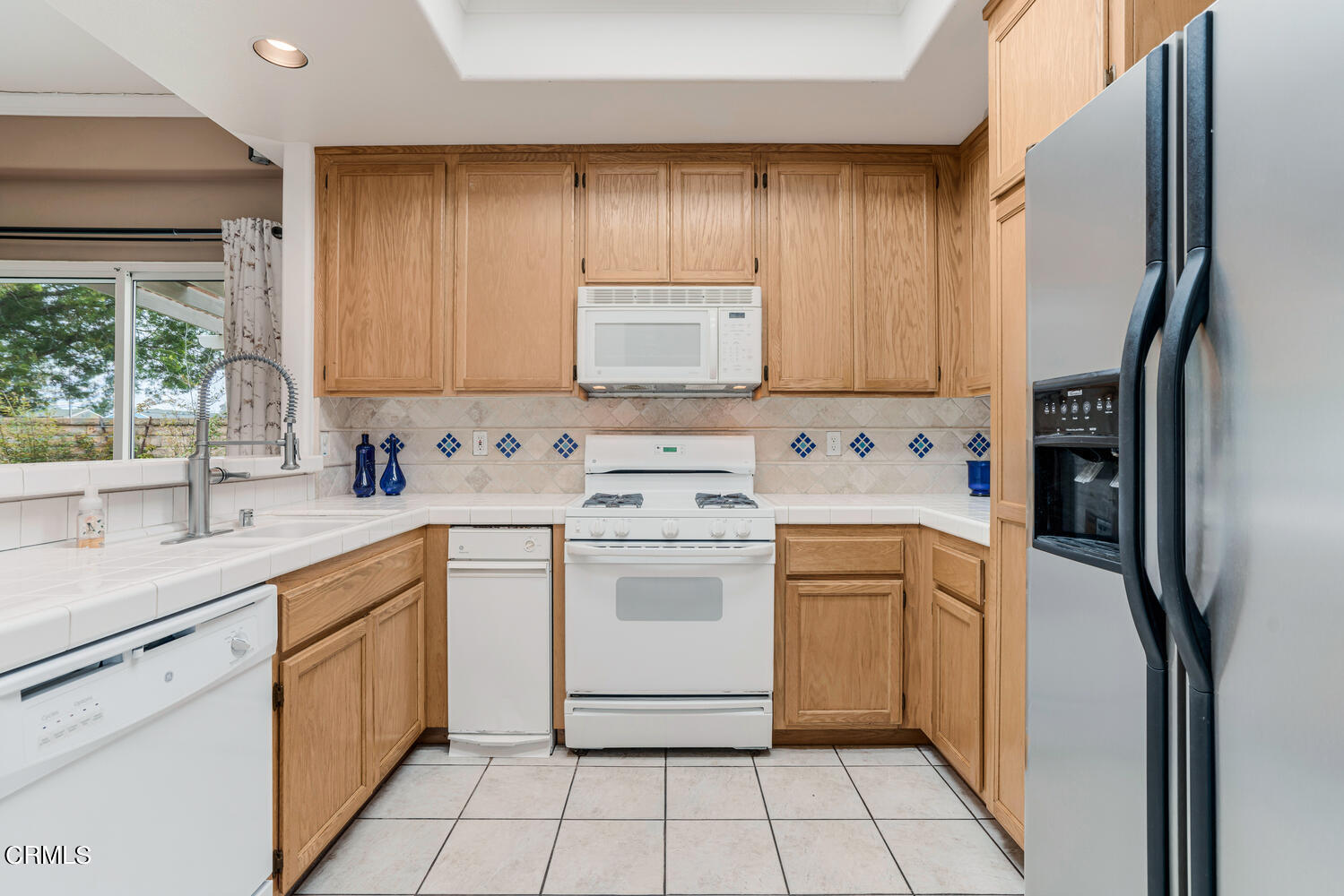 2911 Pico Place Oxnard, CA 93033 - Photo 7 of 25 a kitchen with a stove sink and cabinets