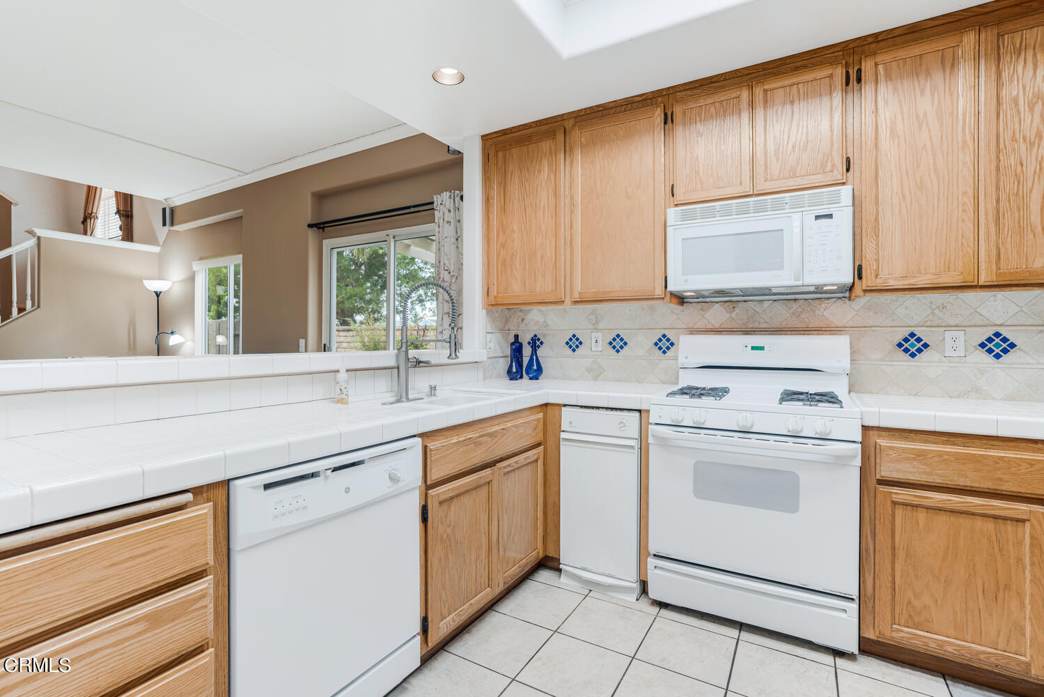 2911 Pico Place Oxnard, CA 93033 - Photo 8 of 25 a kitchen with cabinets appliances a sink and a window