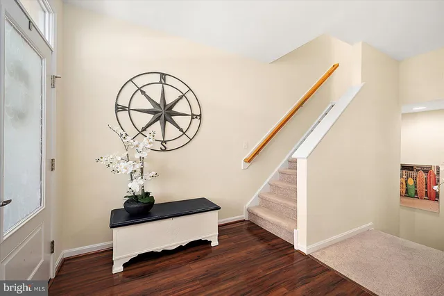 a kitchen with granite countertop white cabinets and appliances