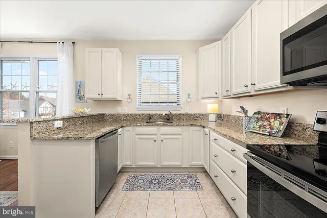 a bedroom with a bed a bed and a chandelier