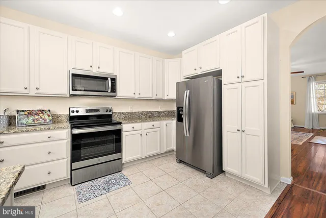 a bedroom with a bed and a ceiling fan