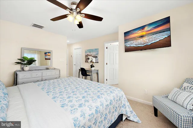 a front view of a house with a yard and potted plants