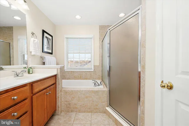 a front view of a house with a yard and potted plants