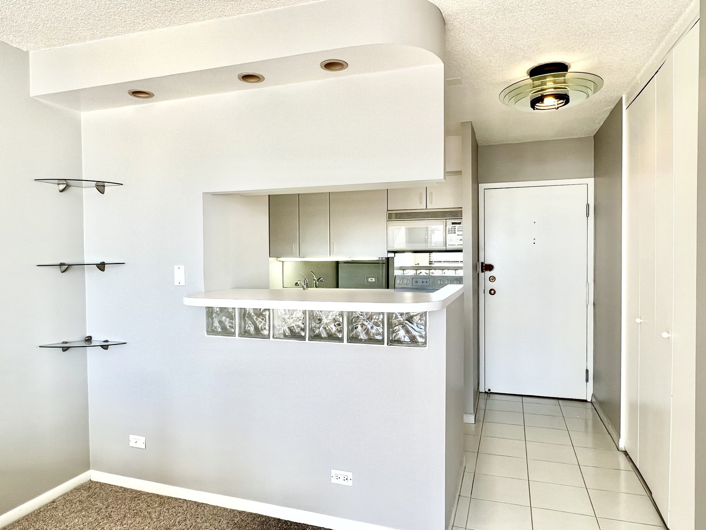 1313 North Ritchie Court, Unit 2703 Chicago, IL 60610 - Photo 4 of 12 a kitchen with kitchen island granite countertop a refrigerator and a sink