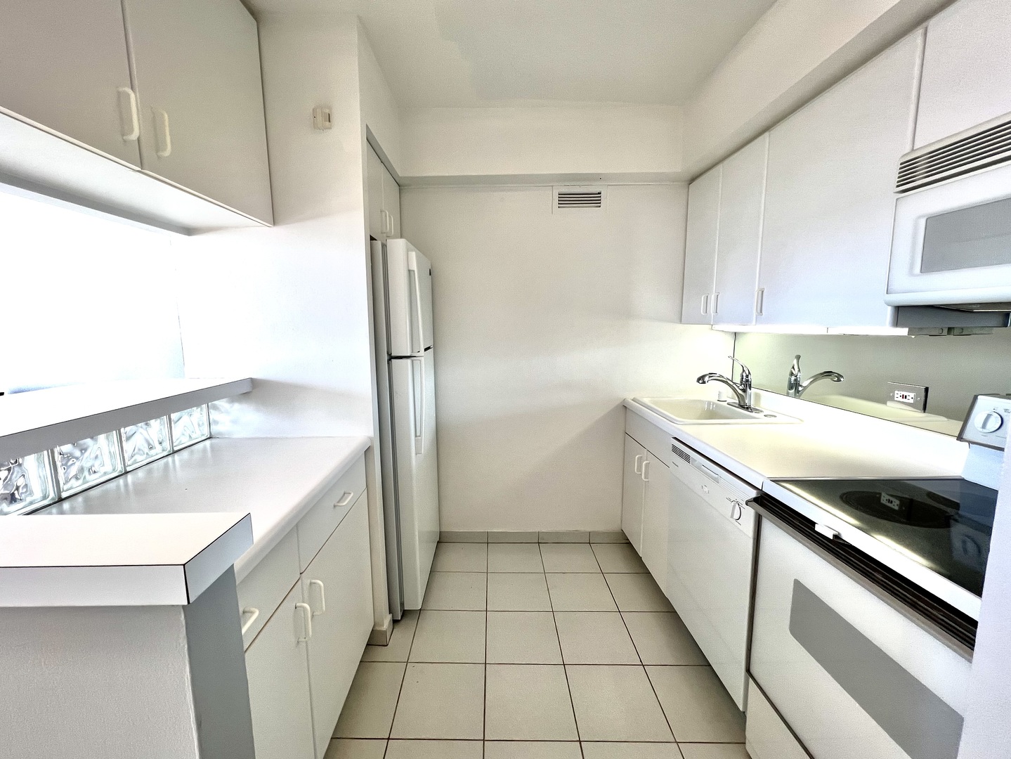 1313 North Ritchie Court, Unit 2703 Chicago, IL 60610 - Photo 6 of 12 a kitchen with a sink a refrigerator and cabinets