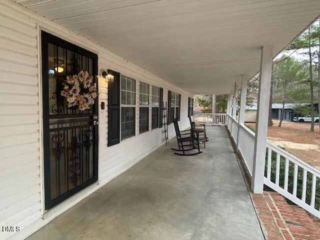 a view of a house with porch and wooden floor
