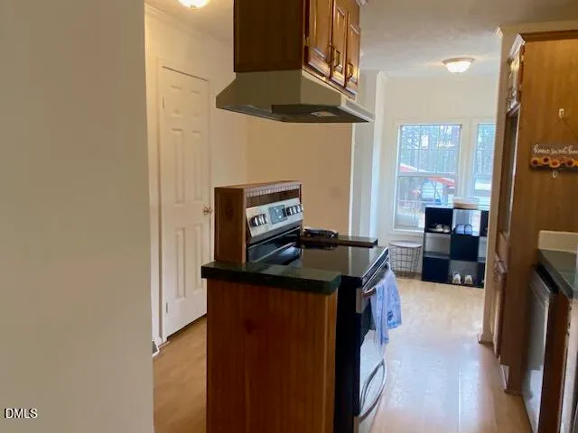 a kitchen with a stove and a refrigerator