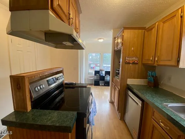 a kitchen with a refrigerator and a stove