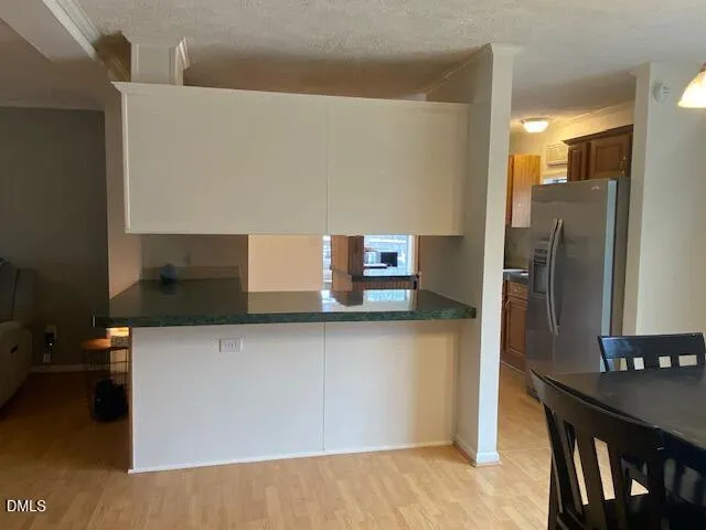 a kitchen with a refrigerator and table