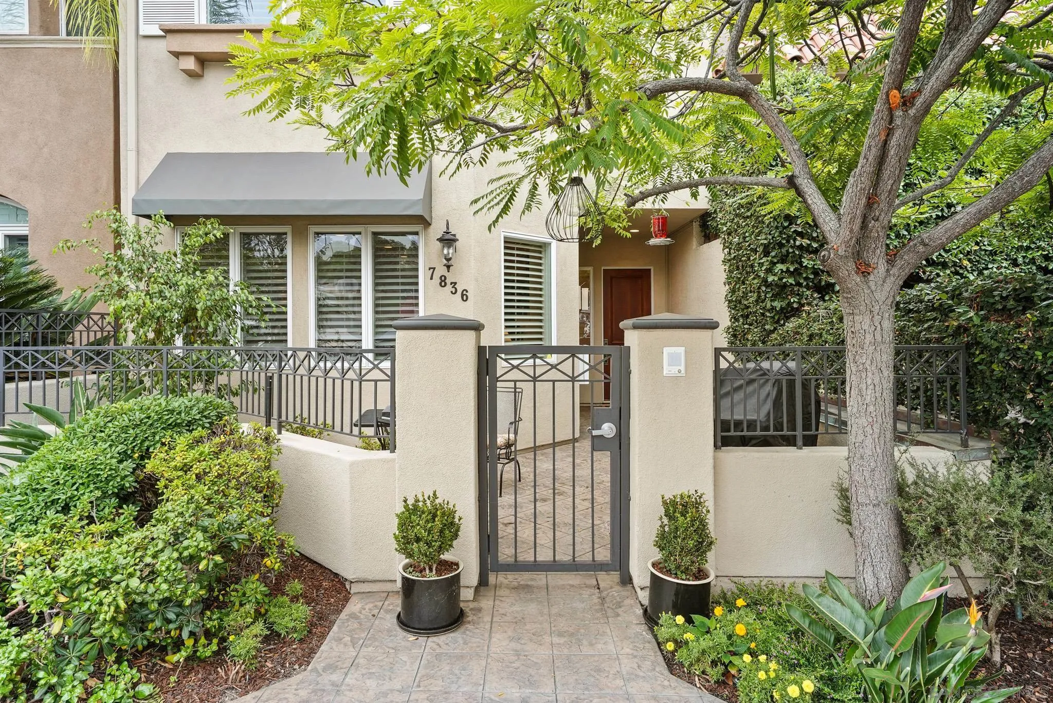 a front view of a house with garden