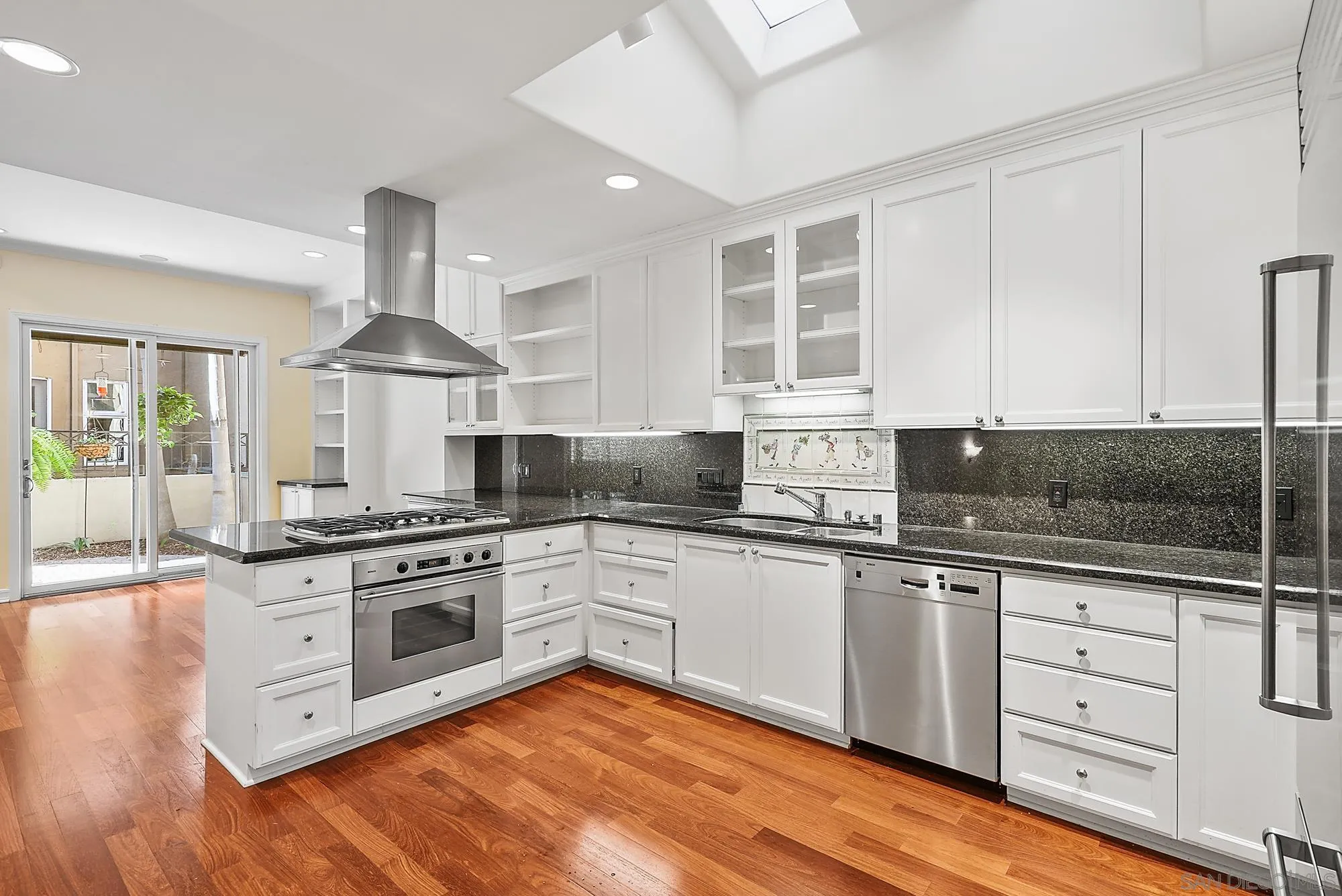 7836 Ivanhoe Avenue La Jolla, CA 92037 - Photo 11 of 31 a kitchen with stainless steel appliances granite countertop a stove and a sink