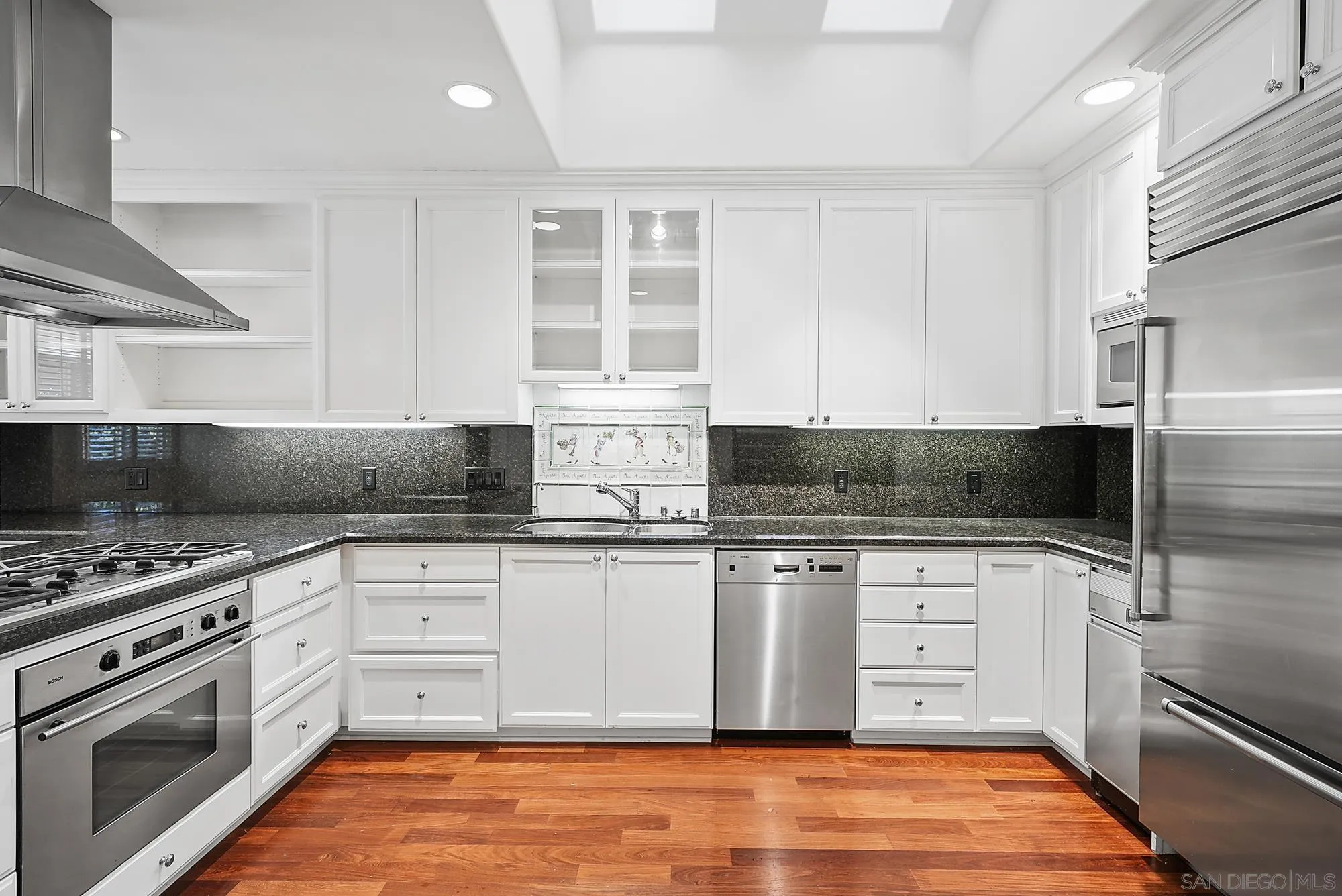 7836 Ivanhoe Avenue La Jolla, CA 92037 - Photo 12 of 31 a kitchen with stainless steel appliances granite countertop a stove a sink and a refrigerator