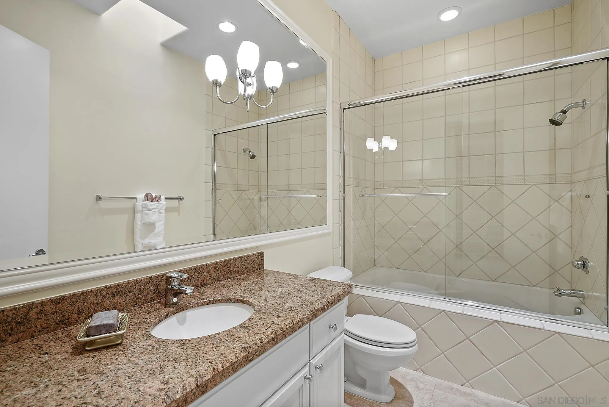7836 Ivanhoe Avenue La Jolla, CA 92037 - Photo 23 of 31 a bathroom with a granite countertop sink a toilet and a mirror