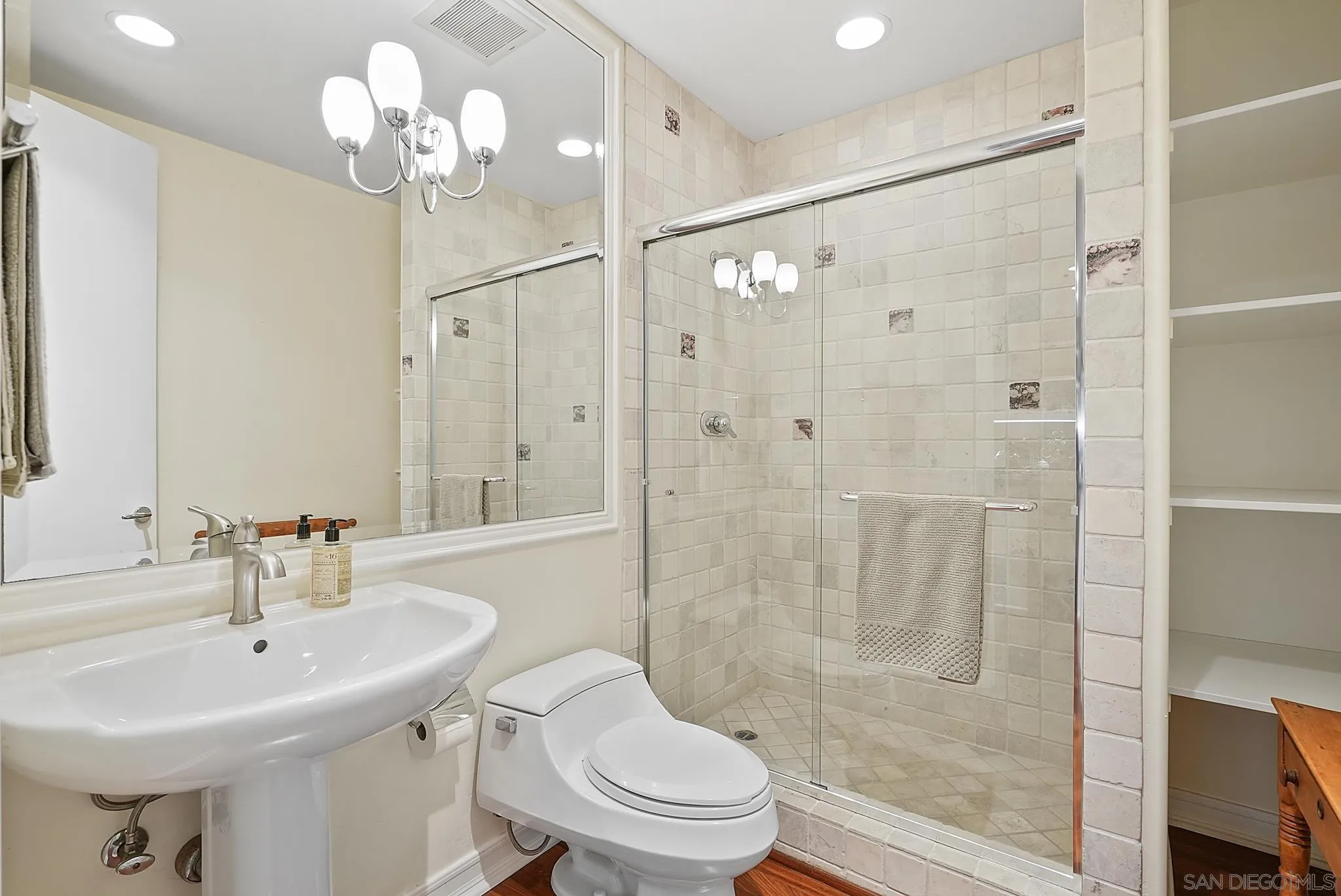 7836 Ivanhoe Avenue La Jolla, CA 92037 - Photo 24 of 31 a bathroom with a sink toilet a mirror and shower