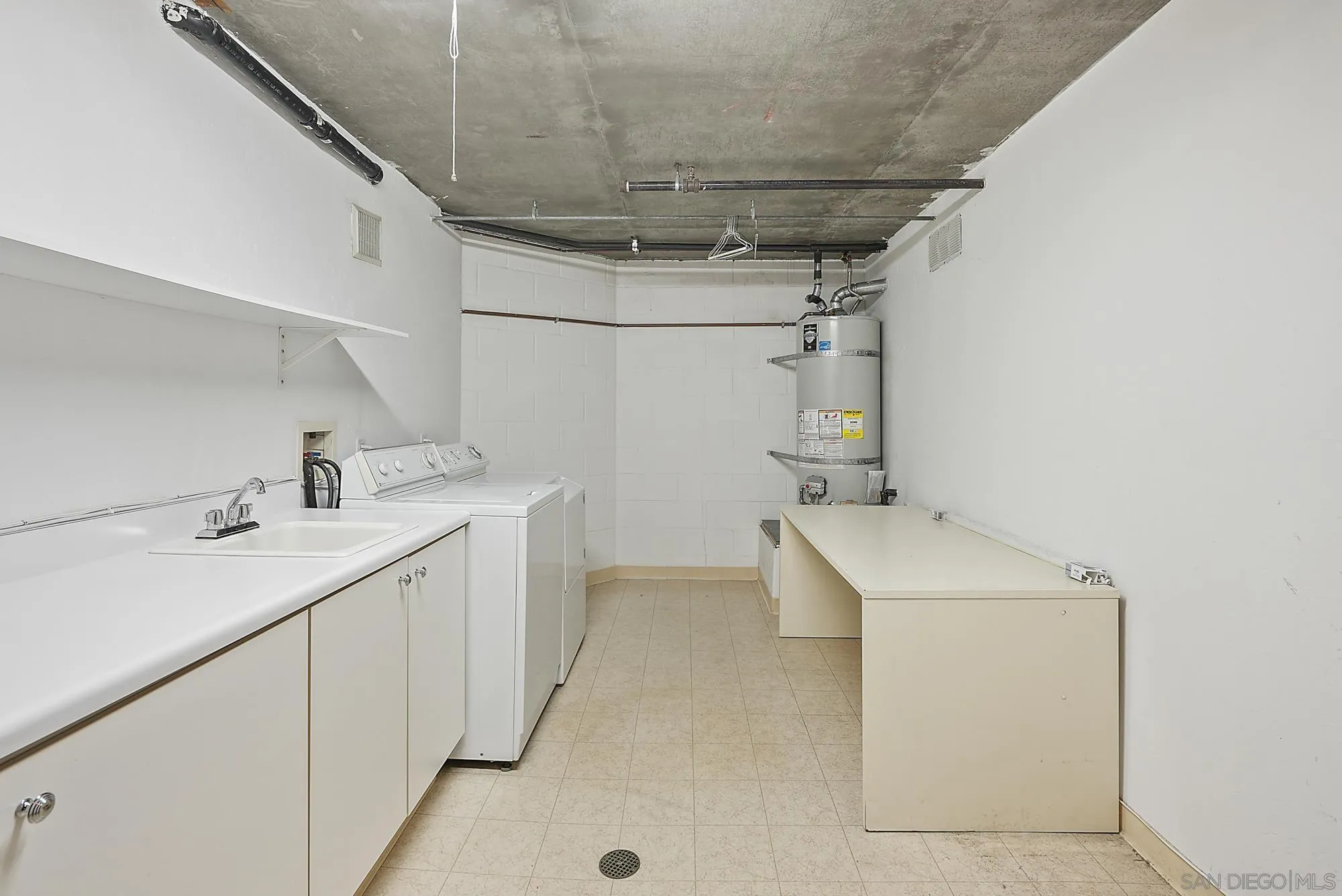 7836 Ivanhoe Avenue La Jolla, CA 92037 - Photo 29 of 31 a utility room with cabinets washer and dryer