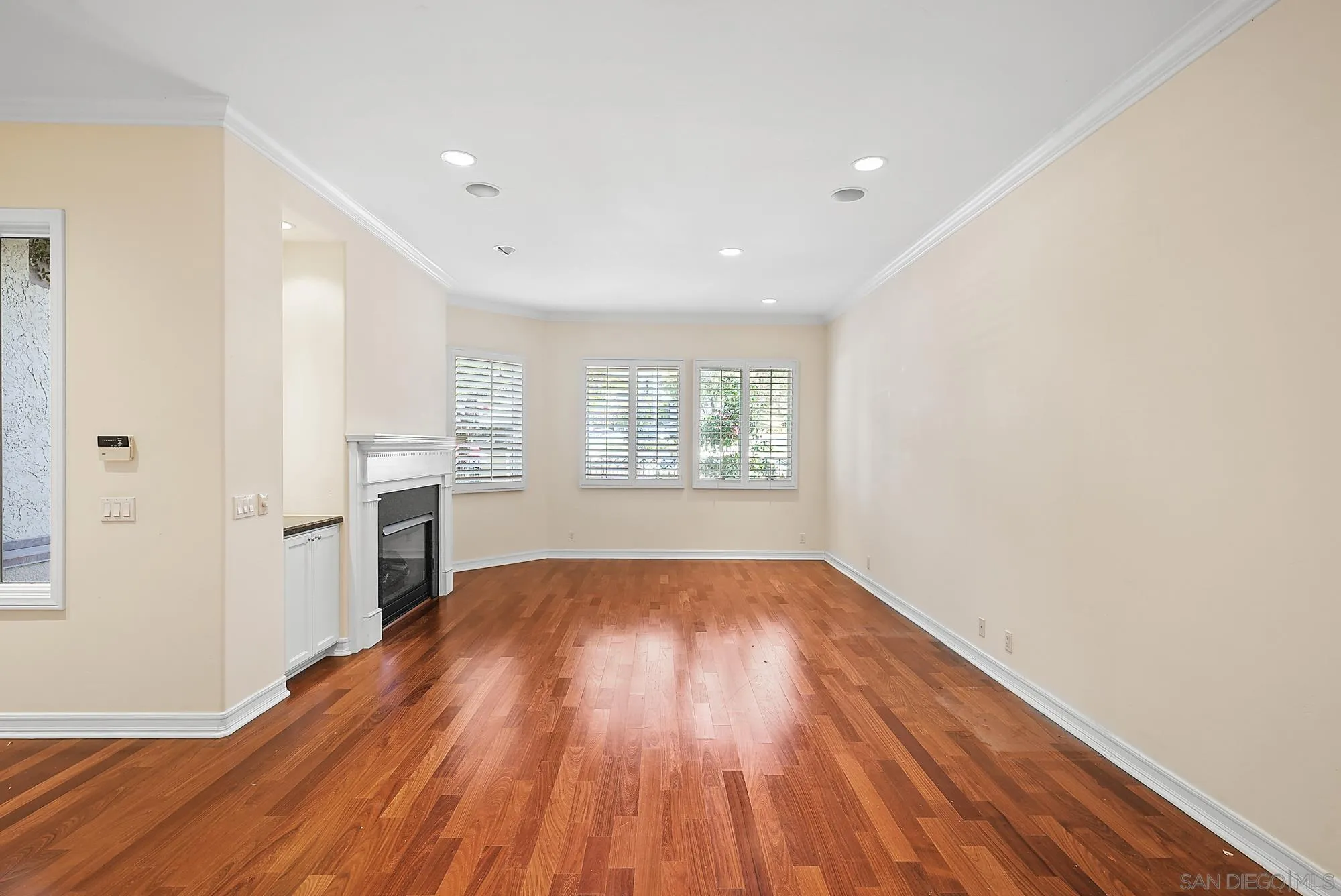 7836 Ivanhoe Avenue La Jolla, CA 92037 - Photo 10 of 31 a view of empty room with wooden floor and window