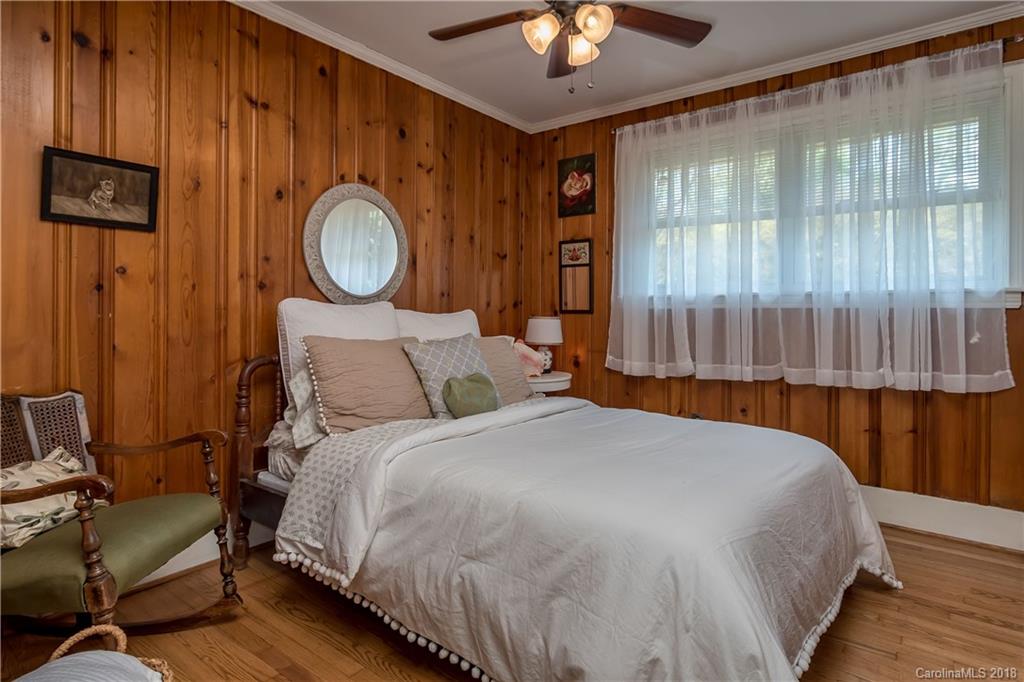 653 Manhasset Road Charlotte, NC 28209 - Photo 22 of 31 a bed sitting in a bedroom next to a window