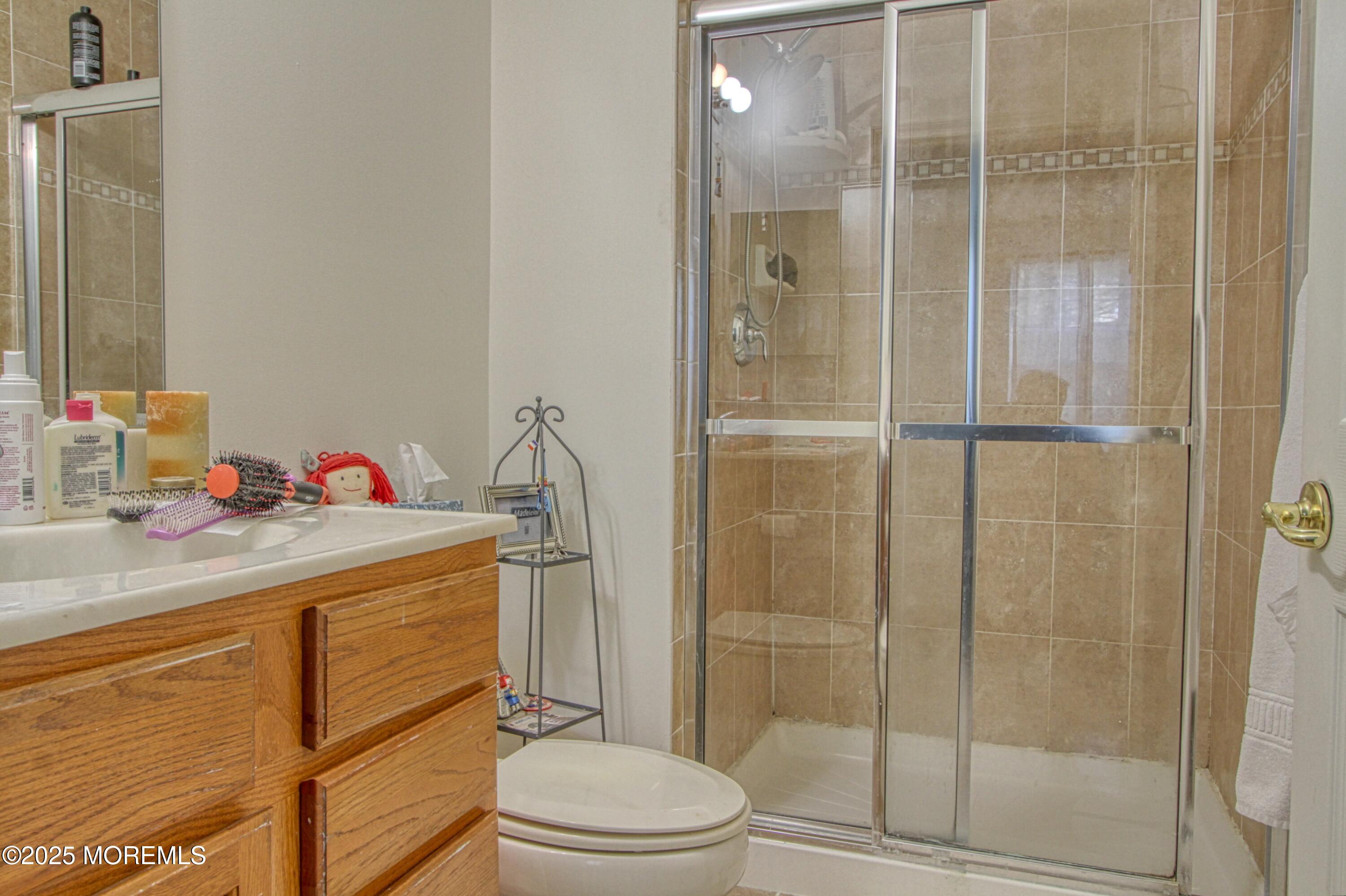 32 Winkle Court Whiting, NJ 08759 - Photo 7 of 18 a bathroom with a sink toilet vanity and shower