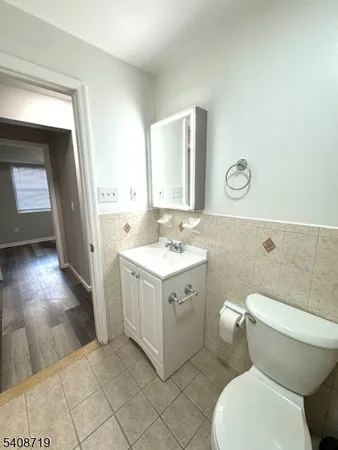 a bathroom with a sink mirror vanity and toilet