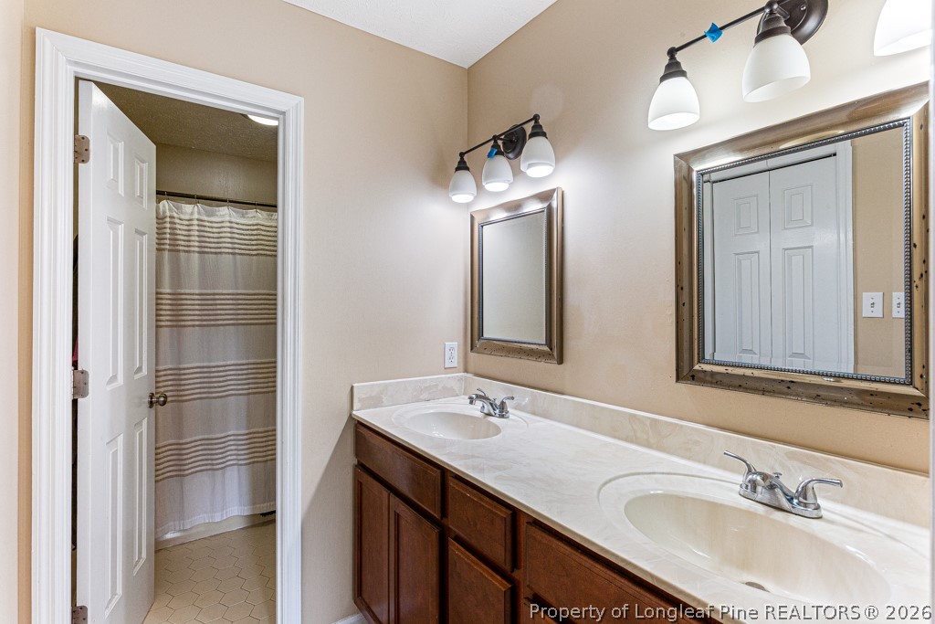 461 Lands End Road Fayetteville, NC 28314 - Photo 20 of 31 a bathroom with a double vanity sink and a mirror
