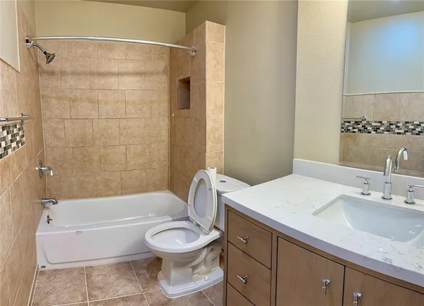 a bathroom with a sink a toilet and a bathtub