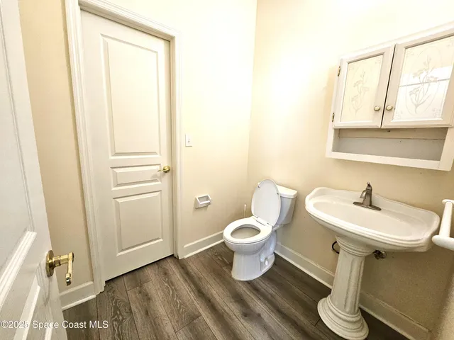 a bathroom with a sink toilet and mirror