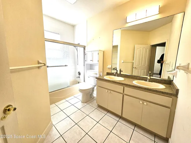 a bathroom with a double vanity sink mirror and