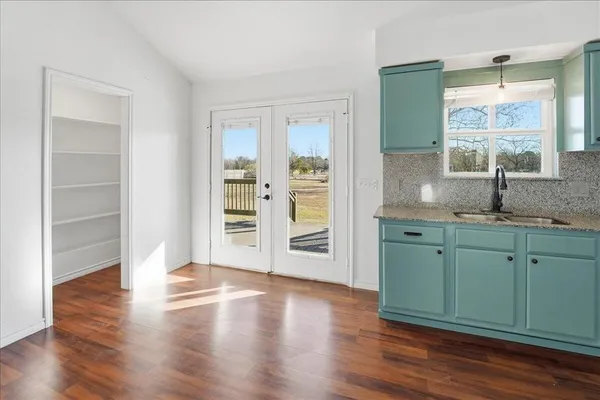 a room with wooden floors and a window