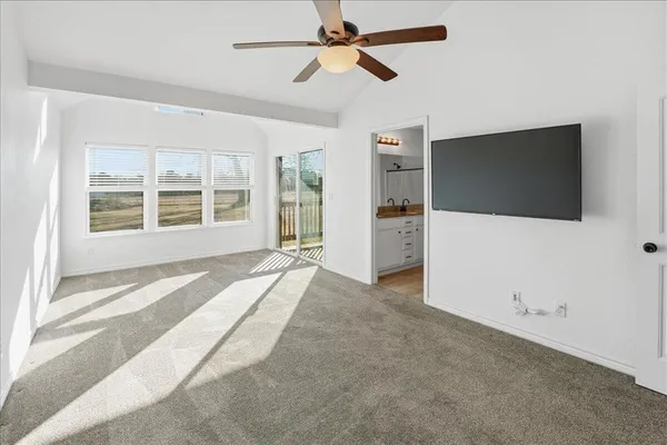 an empty room with windows and cabinet