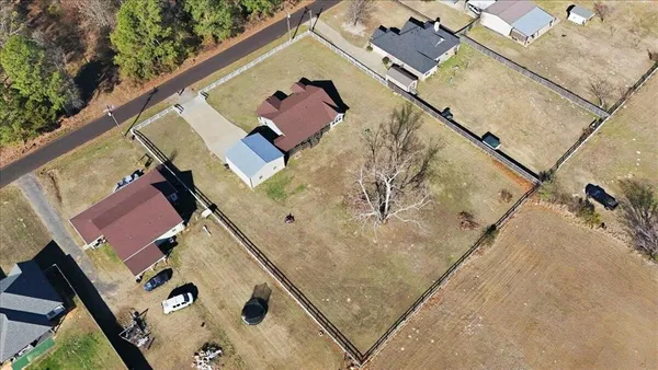 an aerial view of a house with a yard