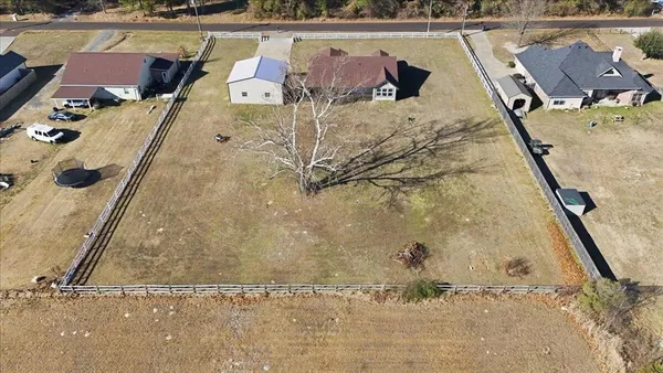 an aerial view of a house with a yard