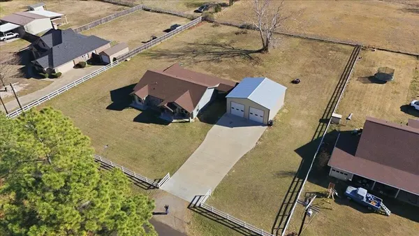 an aerial view of a house with a yard